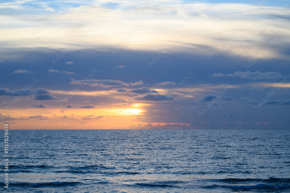 Scenic coast view. Ocean waves background. Sunrise on the sea with clouds background. Scenic coast view. Ocean waves background. Sunrise on the sea with clouds background.