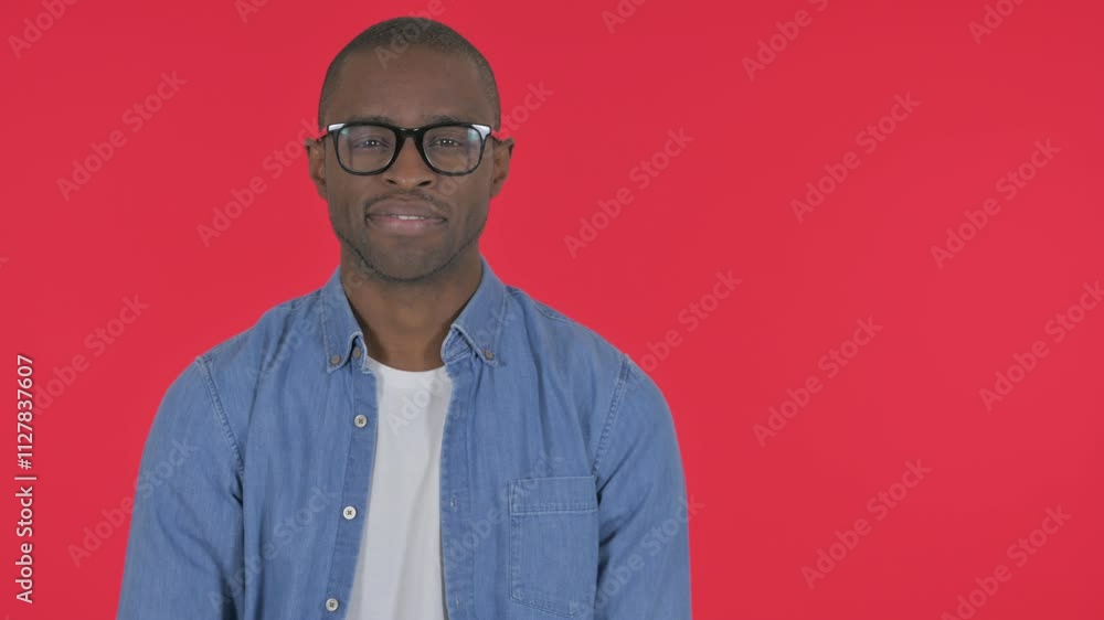 Casual African Man Showing Copyspace on Red Background Casual African Man Showing Copyspace on Red Background