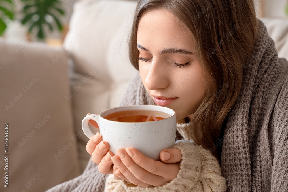Ill young woman drinking lemon tea at home, closeup Ill young woman drinking lemon tea at home, closeup