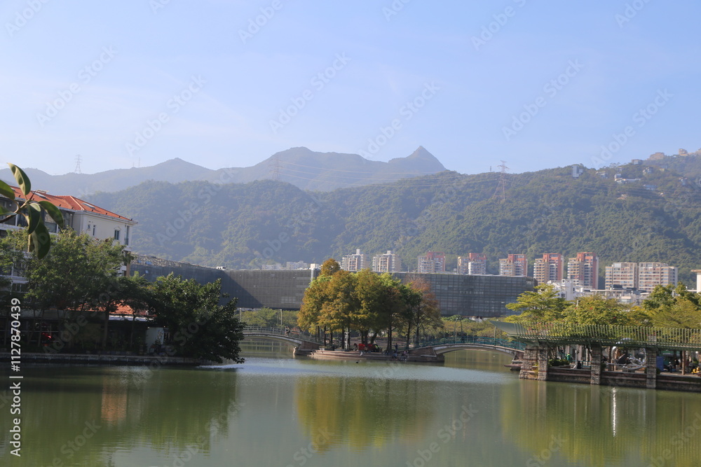 A beautiful lake with a bridge and a few trees A beautiful lake with a bridge and a few trees
