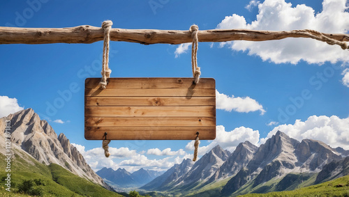 Wooden sign hanging on a rope with a mountain background with blue sky