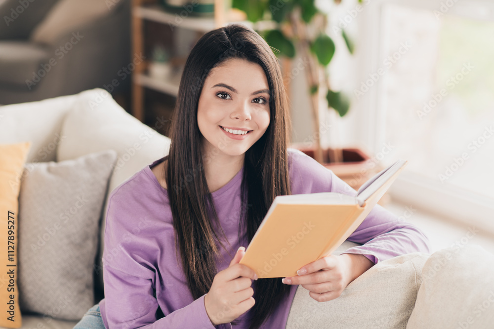 Photo of nice young teen girl reading book wear violet clothes enjoy modern cozy bright interior flat indoors Photo of nice young teen girl reading book wear violet clothes enjoy modern cozy bright interior flat indoors