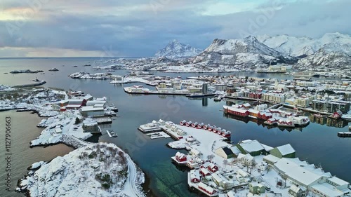 Snowy fishing village surrounded by fjords and mountains in Lofoten, Norway, aerial view photo