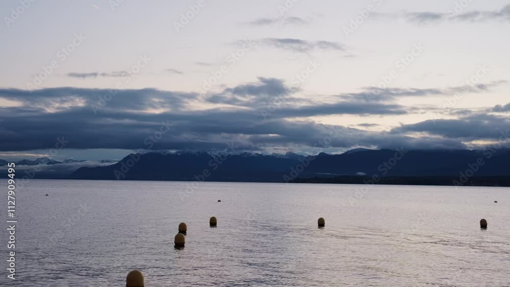 Close establishing shot of Lake Geneva at sunrise from Nyon lakeside in Switzerland Close establishing shot of Lake Geneva at sunrise from Nyon lakeside in Switzerland