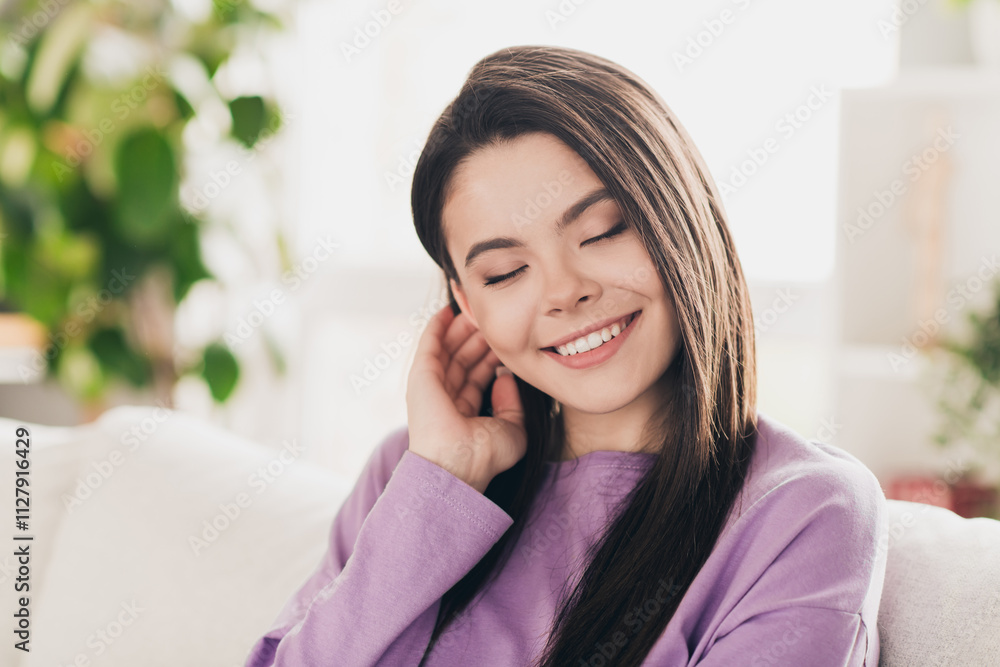 Photo of lovely young teen girl charming tuck hair behind ear dressed violet garment spacious house bright indoors room Photo of lovely young teen girl charming tuck hair behind ear dressed violet garment spacious house bright indoors room