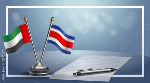 United Arab Emirate and Costa Rica National flags on small table with bokeh background, cooperative relationship