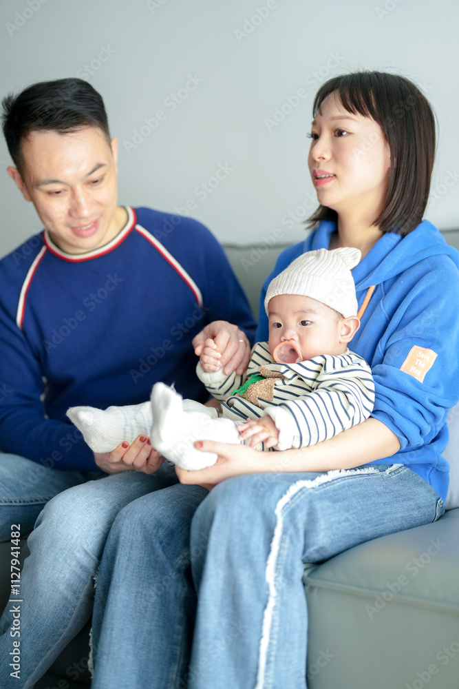 A 6-month-old boy spends time on a couch with his mother and father from a Chinese family on a cold winter day in an apartment building in the Pudong New Area of Shanghai, China. A 6-month-old boy spends time on a couch with his mother and father from a Chinese family on a cold winter day in an apartment building in the Pudong New Area of Shanghai, China.