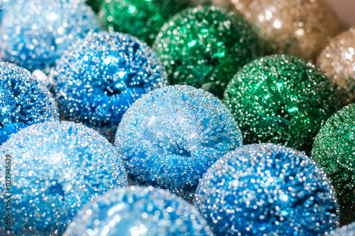 Close-up of Christmas blue, green, and sparkling balls lined up in a row photo