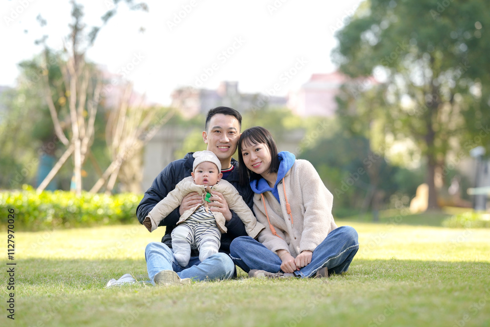 A 6-month-old boy plays with his mother and father from a Chinese family in a private garden in Pudong New Area, Shanghai, China. A 6-month-old boy plays with his mother and father from a Chinese family in a private garden in Pudong New Area, Shanghai, China.