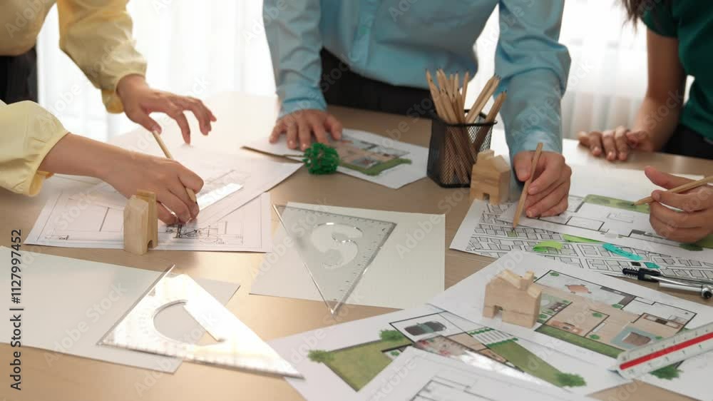 A video of architect use measurement tools and pencil to measure blueprint. Architect design house construction on a table at studio, with architectural plan scattered around. Focus hand. Delineation. A video of architect use measurement tools and pencil to measure blueprint. Architect design house construction on a table at studio, with architectural plan scattered around. Focus hand. Delineation.