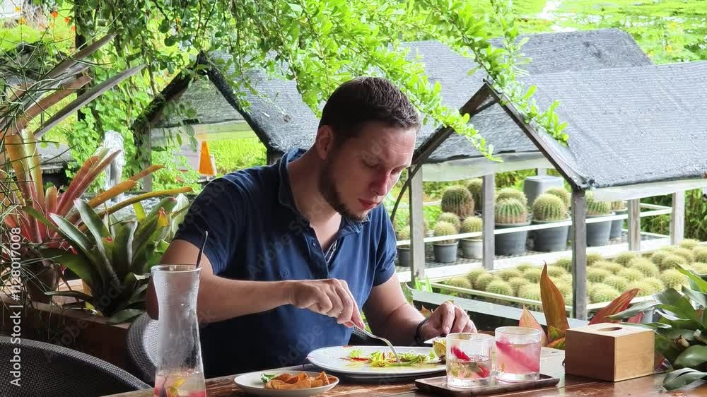 A man is relishing a delightful meal and drinks in a modern cafe A man is relishing a delightful meal and drinks in a modern cafe