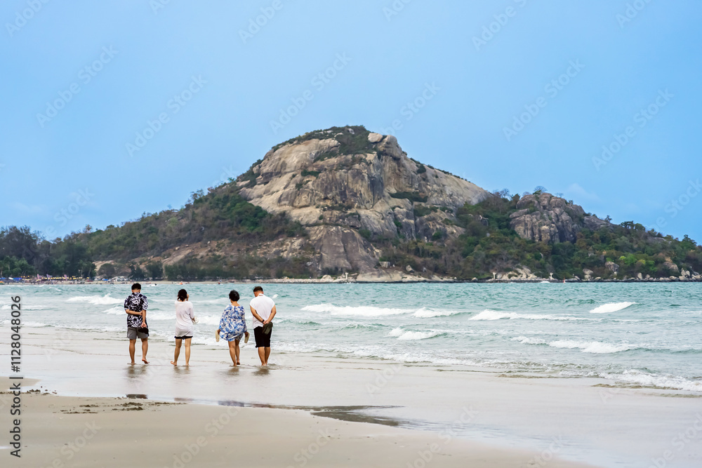 Back view of happy carefree family walk in sea at beach. Summer, travel and relax with family on beach for vacation, bonding and love. Freedom,Group of people walk together at seaside.Holiday outdoors Back view of happy carefree family walk in sea at beach. Summer, travel and relax with family on beach for vacation, bonding and love. Freedom,Group of people walk together at seaside.Holiday outdoors