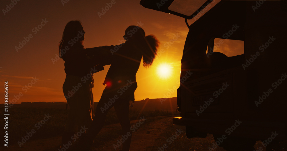 Obraz premium Road trip, silhouette and sunset with friends outdoor together for holiday, travel or vacation. Carry, countryside and vehicle with people in dark nature park for adventure, camping or journey