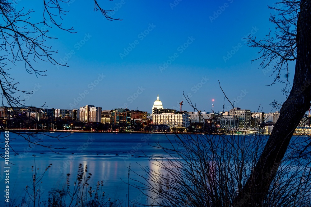 Downtown Madison, WI and the Wisconsin State Capitol Building behind Lake Monona at Twilight