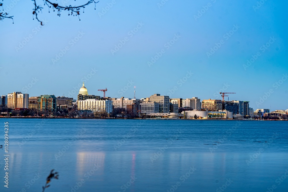 Downtown Madison, WI and the Wisconsin State Capitol Building behind Lake Monona at Twilight