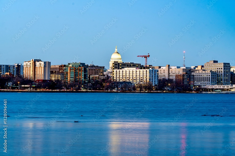 Downtown Madison, WI and the Wisconsin State Capitol Building behind Lake Monona at Twilight