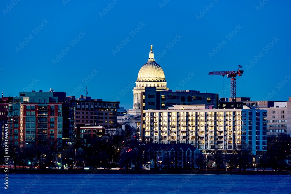 Downtown Madison, WI and the Wisconsin State Capitol Building behind Lake Monona at Twilight