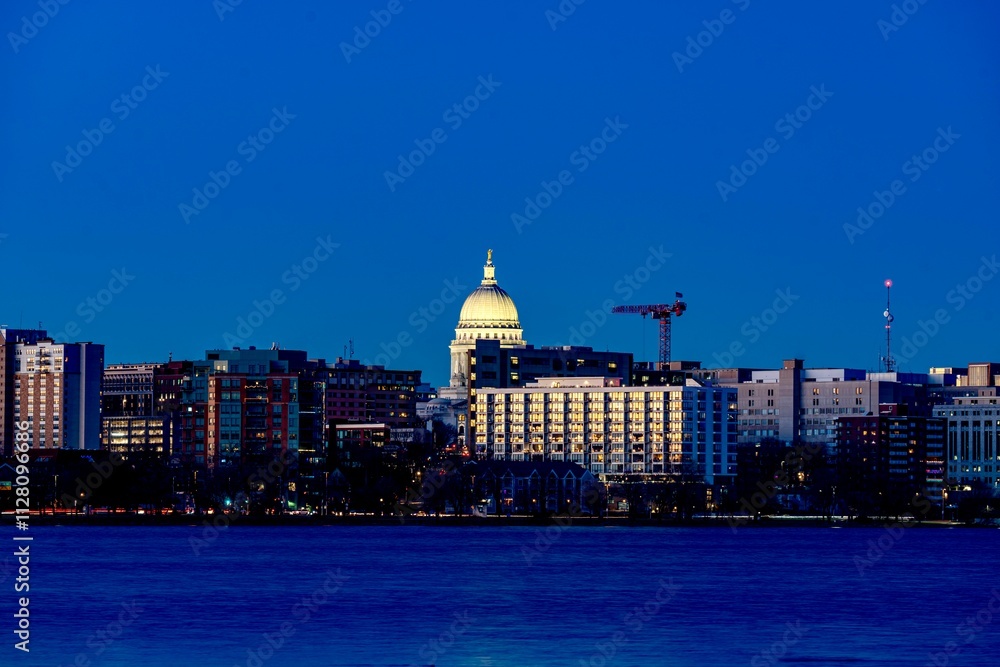 Downtown Madison, WI and the Wisconsin State Capitol Building behind Lake Monona at Twilight