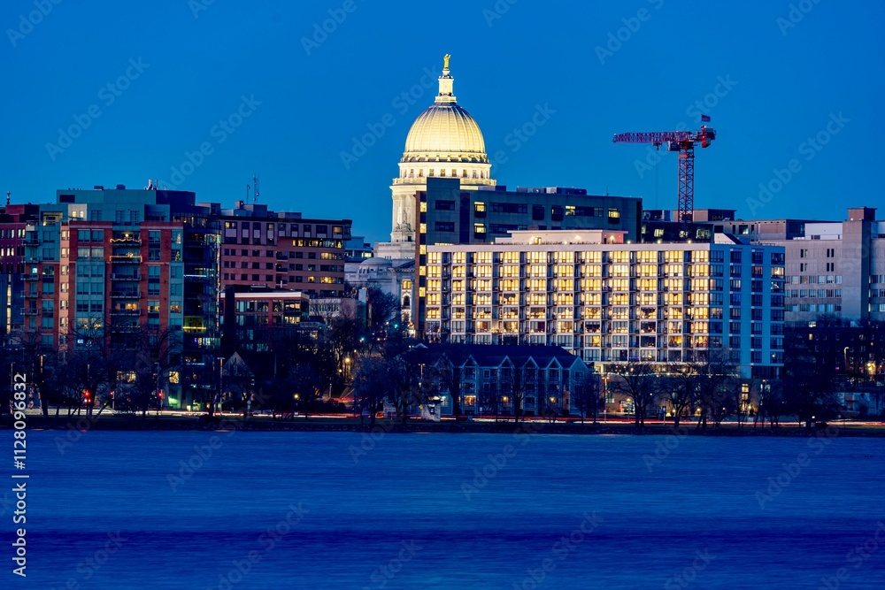 Downtown Madison, WI and the Wisconsin State Capitol Building behind Lake Monona at Twilight