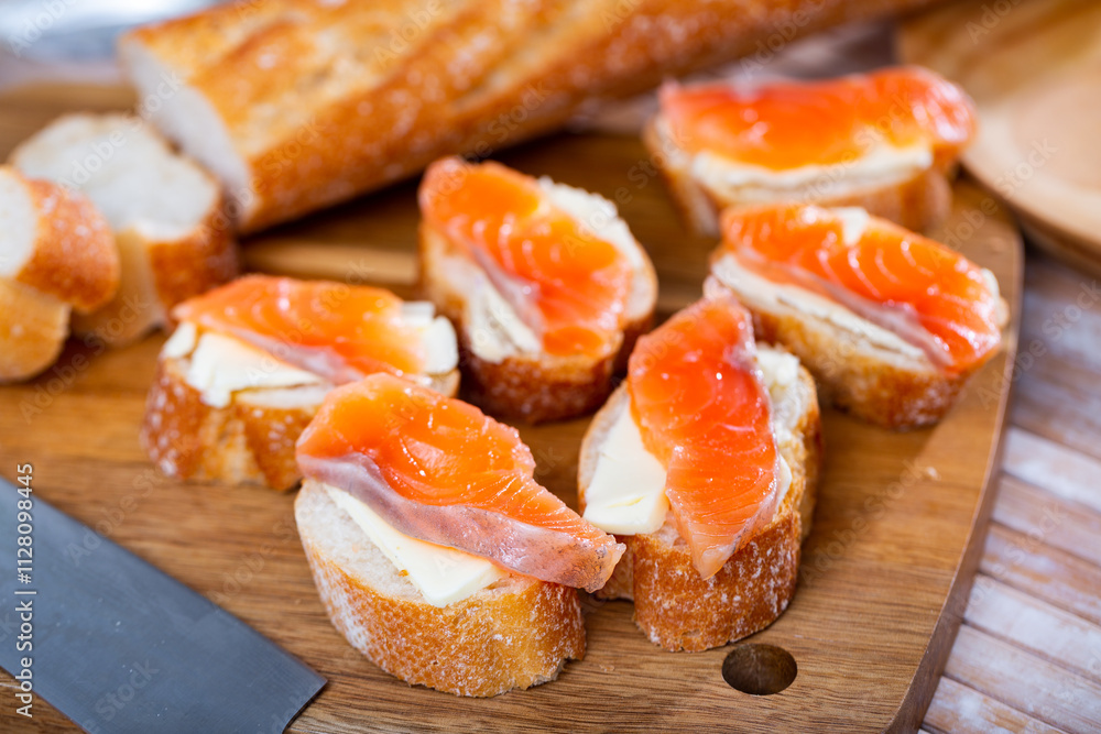 Delicious sandwiches with salmon and butter on a white plate Delicious sandwiches with salmon and butter on a white plate