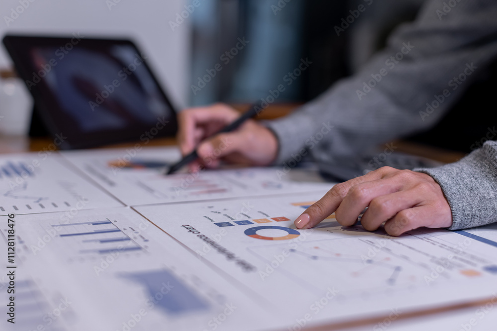 Close up of businesswoman Accounting using calculating income-expenditure and analyzing real estate investment data report Financial and tax systems concept. Close up of businesswoman Accounting using calculating income-expenditure and analyzing real estate investment data report Financial and tax systems concept.