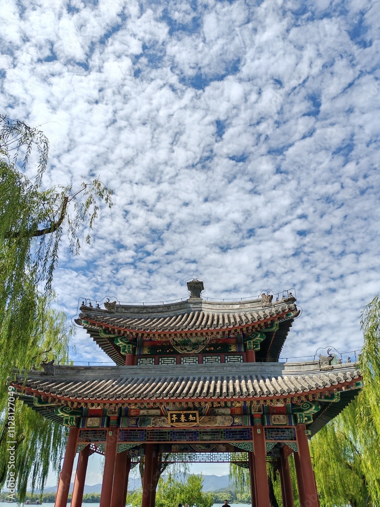 BEIJING, CHINA - 6th September 2024: The Heralding Spring Pavilion in Summer Palace Beijing under cloudy blue sky BEIJING, CHINA - 6th September 2024: The Heralding Spring Pavilion in Summer Palace Beijing under cloudy blue sky