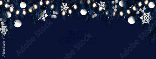 Christmas border with glowing string lights and dark blue evergreen branches. Night scene featuring white ornaments, silver snowflakes and greeting text. Noel holiday header or winter seasonal banner.