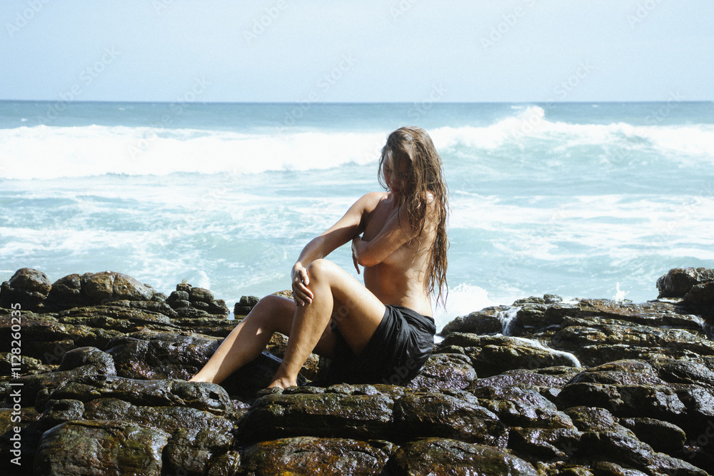 Woman on the rocks of a beach Woman on the rocks of a beach