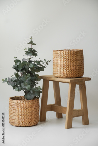 A rustic wicker basket overflowing with a vibrant assortment of fresh herbs, including parsley, nestled amongst lush green leaves, perfect for culinary creations or a touch of natural beauty