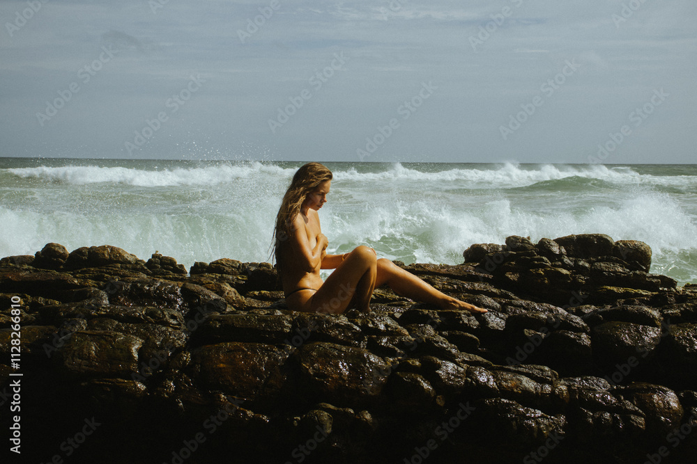 Woman on the rocks of a beach Woman on the rocks of a beach