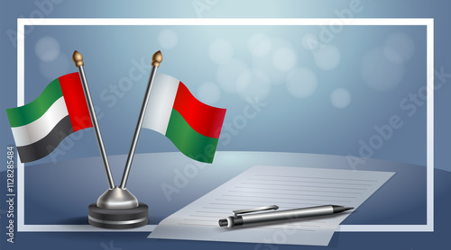 United Arab Emirate and Madagascar National flags on small table with bokeh background, cooperative relationship