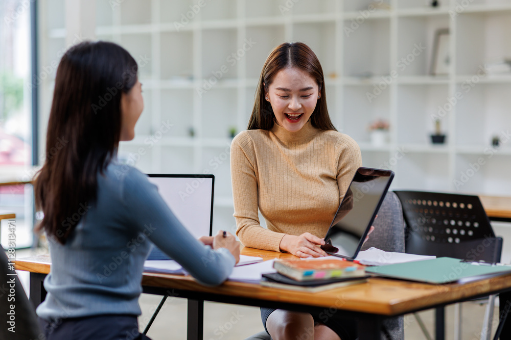 © David - Two asian female creative agency casual meeting discussion working with laptop, analyze planning and financial statistics and investment market at office.
