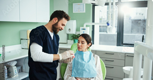 Photos Dentist, mouth model and man with woman in clinic for teeth cleaning, dental hygiene and demonstration