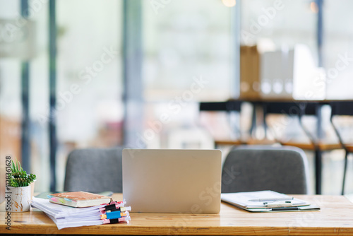 Wallpaper Mural Laptop Computer, notebook, and eyeglasses sitting on a desk in a large open plan office space after working hours	 Torontodigital.ca