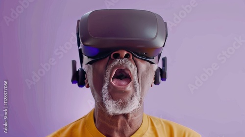 An elderly man wearing opaque virtual reality goggles, with a thrilled expression photo