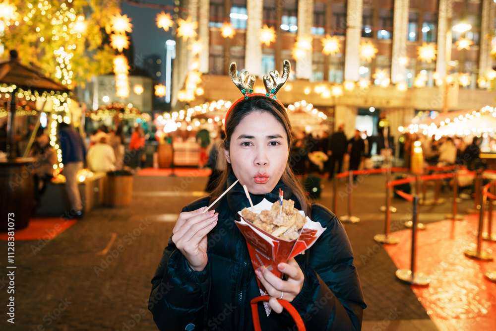 Woman eating Christmas food with snack and sausage at German Christmas market. Merry Christmas and happy New Year concept Woman eating Christmas food with snack and sausage at German Christmas market. Merry Christmas and happy New Year concept
