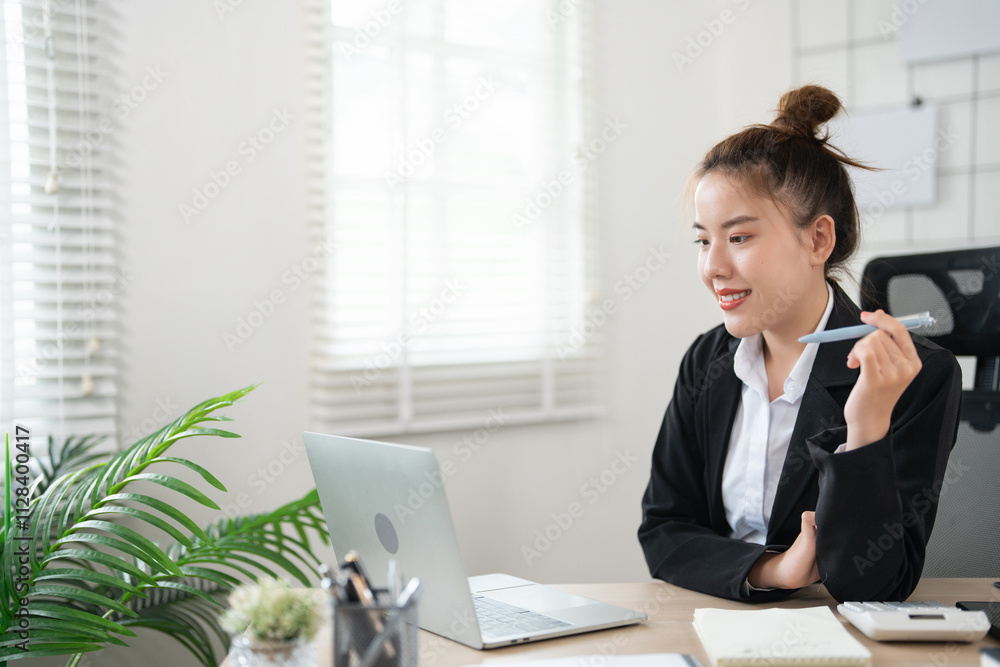 young asian woman working at her desk, writing notes. Businesswoman at her workplace. young asian woman working at her desk, writing notes. Businesswoman at her workplace.