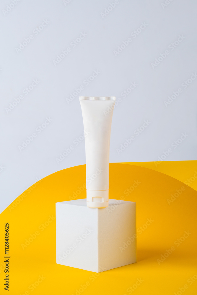 Cosmetic product in tube, bottle, lotion or serum on yellow background with stylish props. Cosmetic product in tube, bottle, lotion or serum on yellow background with stylish props.