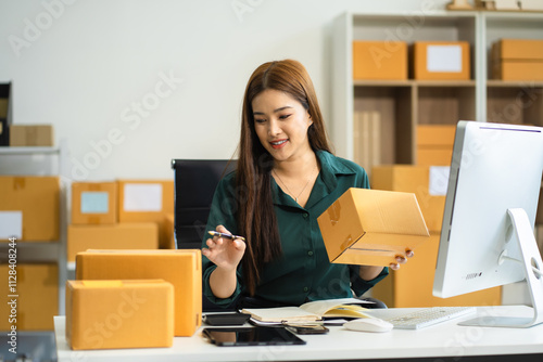 Woman selling products online.entrepreneur or freelance checking orders from customers, woman runs an e-commerce business on websites and social media.