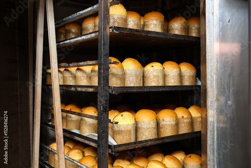 Wallpaper Mural A rack of breads with a wooden handle, Easter baking at the factory Torontodigital.ca