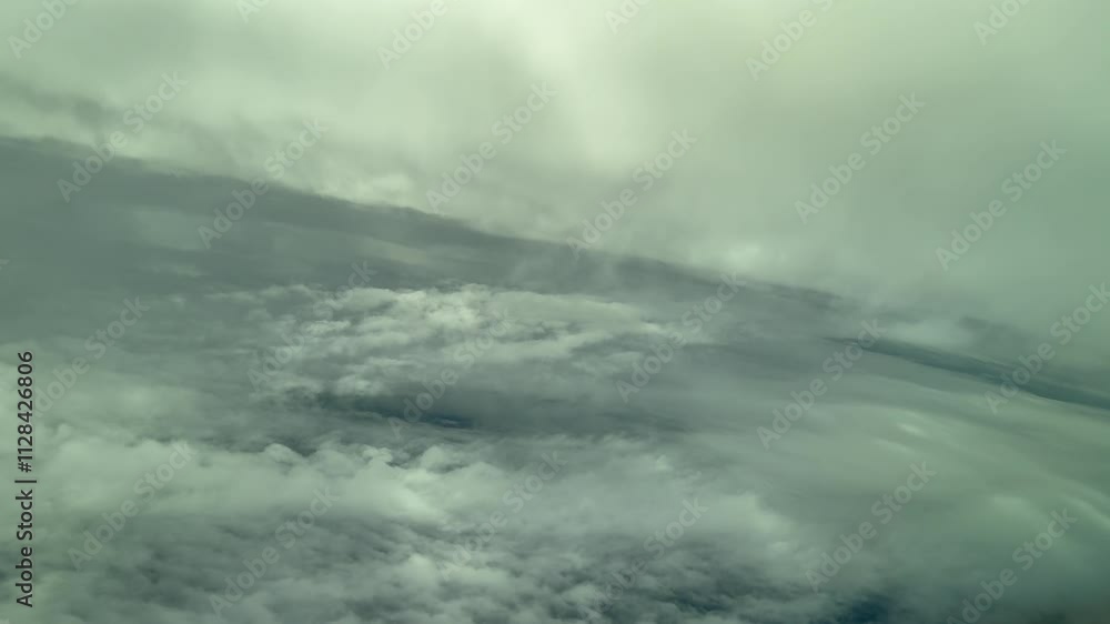 Immersive pilot’s FPV flying throug a cold winter sky plenty of snow clouds as seen by the pilots from the cockpit while doing a left turn. 4K 60FPS