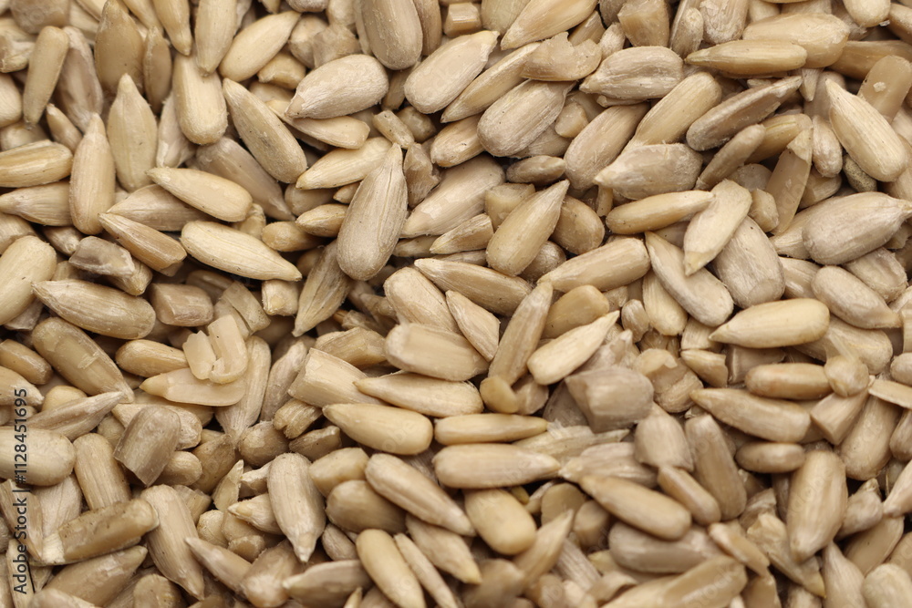 A CloseUp View of Shelled Sunflower Seeds Displayed on a Beautiful Wooden Surface A CloseUp View of Shelled Sunflower Seeds Displayed on a Beautiful Wooden Surface