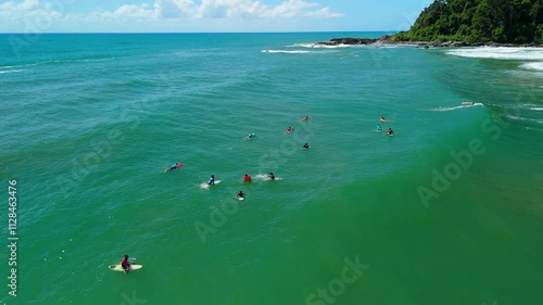 Aerial view of surfers waving while waiting for waves at Praia da Engenhoca, Itacare, Bahia photo