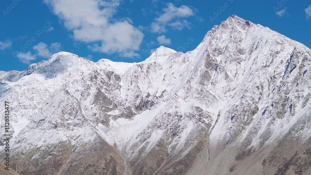 Fresh snow on the dry Himalayan mountain peaks during a sunny cloudy day after the winter storm at Spiti Valley in Himachal Pradesh, India. Fresh snow on Himalayas in winter season. Winter background. Fresh snow on the dry Himalayan mountain peaks during a sunny cloudy day after the winter storm at Spiti Valley in Himachal Pradesh, India. Fresh snow on Himalayas in winter season. Winter background.