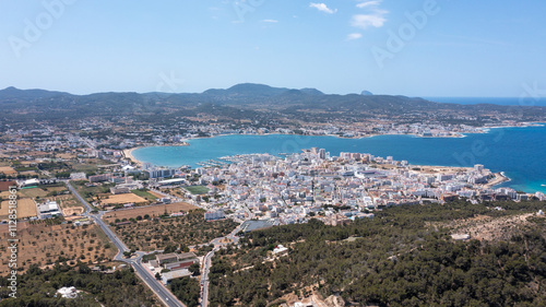 Aerial drone photo of a beach in the town of Sant Antoni de Portmany on the island of Ibiza in the Balearic Islands Spain showing the boating harbour and the beach known as Playa de San Antonio