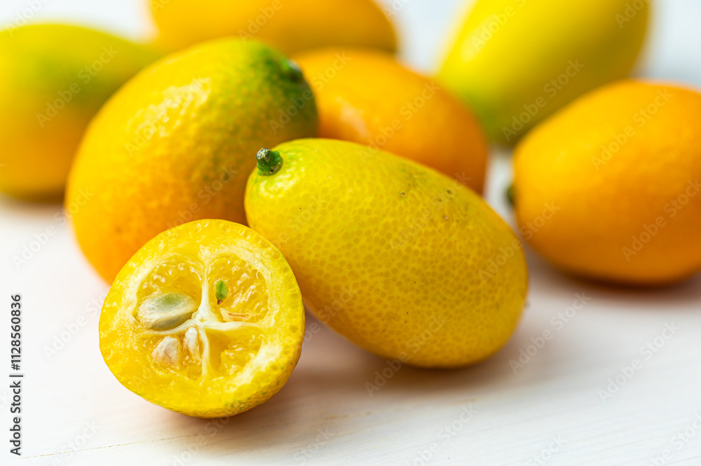 Ripe Chinese mandarins, or Kingen, on white wooden surface. Ripe Chinese mandarins, or Kingen, on white wooden surface.