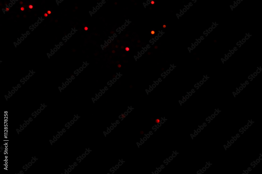 Red blurred bokeh lights on black background. Glitter sparkle confetti Red blurred bokeh lights on black background. Glitter sparkle confetti