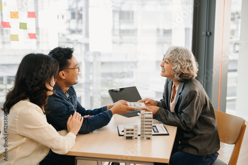 A family couple sign a lease meeting with a realtor or homeowner, purchase the first mortgage and mortgage ownership concept. photo