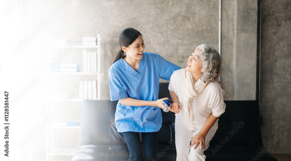Asian caregiver doctor examine older patient woman therapist nurse at nursing home taking care of senior elderly woman sit on sofa Asian caregiver doctor examine older patient woman therapist nurse at nursing home taking care of senior elderly woman sit on sofa