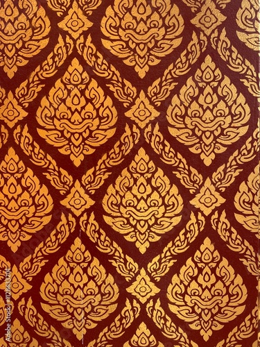 Golden Thai pattern background on the red wall of a beautiful Thai temple.